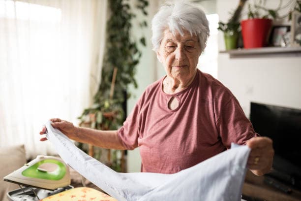 Caregiver helping a senior with daily tasks at home